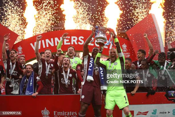 Leicester City's English-born Jamaican defender Wes Morgan and Leicester City's Danish goalkeeper Kasper Schmeichel hold up the winner's trophy as...