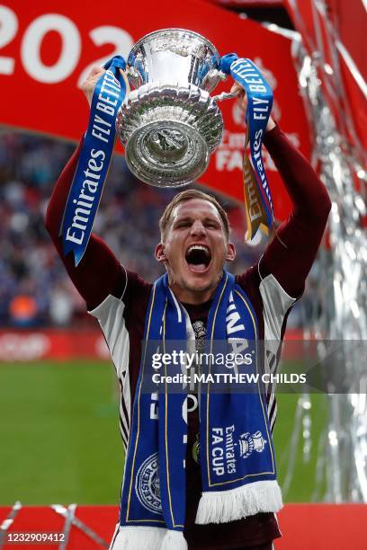 Leicester City's English midfielder Marc Albrighton holds up the winner's trophy as the Leicester players celebrate victory after the English FA Cup...