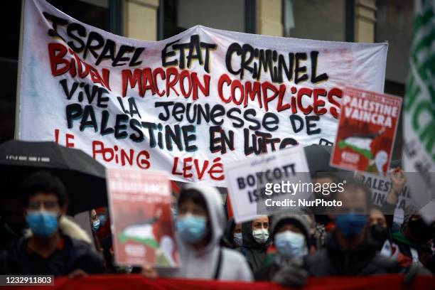The abnner reads 'Israel criminal state, MBiden, Macron accomplices'. Hundreds of people gathered in support of Gaza and the Occupied Territories as...
