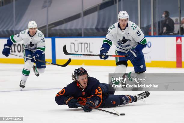 Joakim Nygard of the Edmonton Oilers handles the puck as he falls on the ice against Tyler Myers of the Vancouver Canucks at Rogers Place on May 15,...
