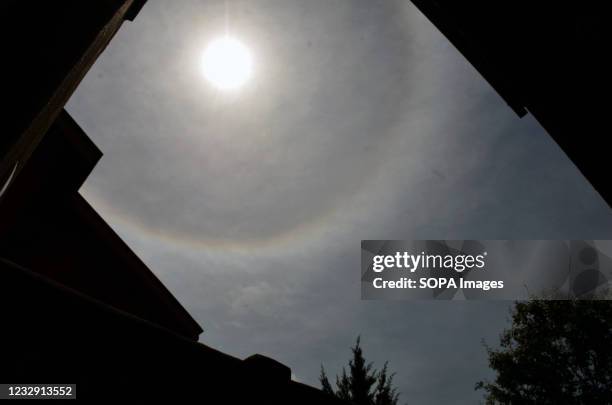 The halo phenomenon is seen around the sun in Srinagar. Sun halos are caused by light interacting with ice crystals in the atmosphere.