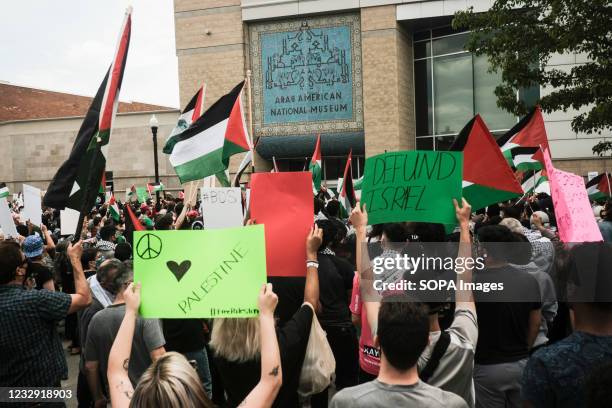 Protesters waving Palestinian flags and placards during a large free Palestine rally at the Arab American Museum. Hundreds of residents of Detroit...