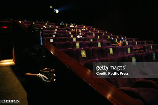 The atmosphere of the audience in the theater sitting at a distance and wearing mask before the screening of the film at XXI Cinema, Kuningan area on...