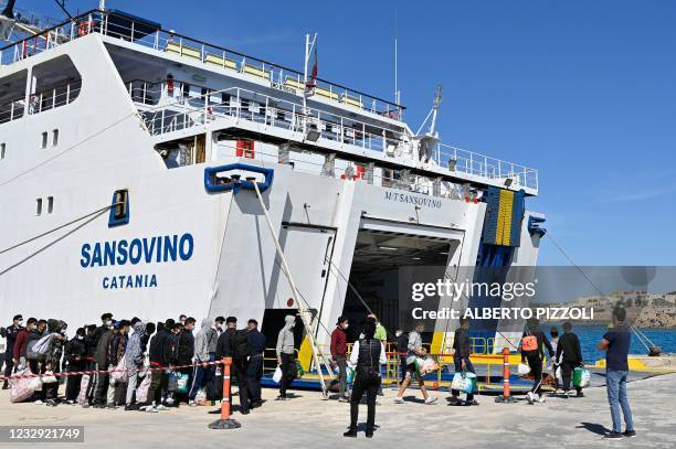 Migrants, some under 15 years old of various nationalities, assisted by NGO Save The Children Italia, wait to board a ferry to be transferred to...