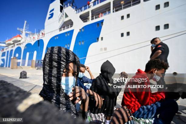 Migrants, some under 15 years old of various nationalities, assisted by NGO Save The Children Italia, wait to board a ferry to be transferred to...