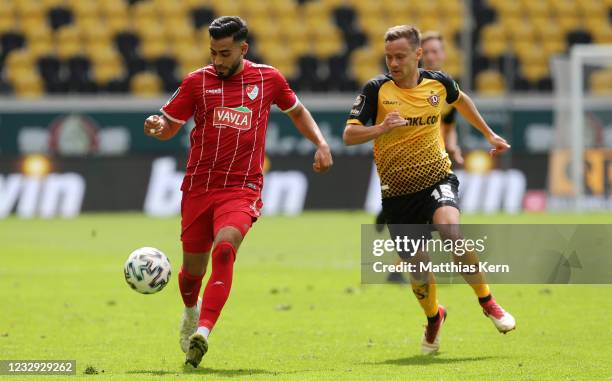 Chris Loewe of Dresden challenges for the ball with Uenal Tosun of Muenchen during the 3. Liga match between Dynamo Dresden and Tuerkguecue Muenchen...