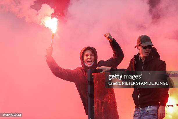 Feyenoord football club supporters burn flares during the Dutch Eredivisie match between Feyenoord and RKC Waalwijk in the Kuip in Rotterdam on May...