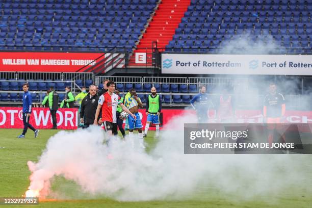 Feyenoord football club supporters throw fireworks on the pitch during the Dutch Eredivisie match between Feyenoord and RKC Waalwijk in the Kuip in...