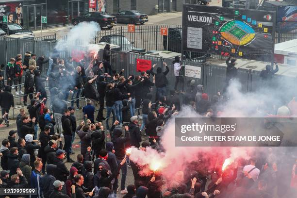 Feyenoord football club supporters burn flares as they gather outside the stadium during the Dutch Eredivisie match between Feyenoord and RKC...