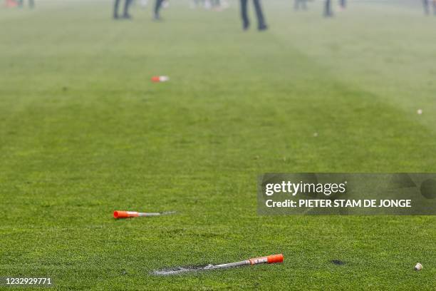 Fireworks lie on the pitch after being lobbed by football supporters during the Dutch Eredivisie match between Feyenoord and RKC Waalwijk in the Kuip...