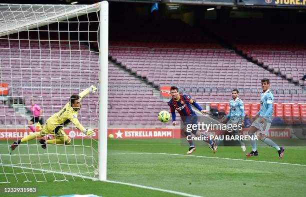 Barcelona's Argentine forward Lionel Messi heads the ball to score a goal during the Spanish League football match between FC Barcelona and RC Celta...