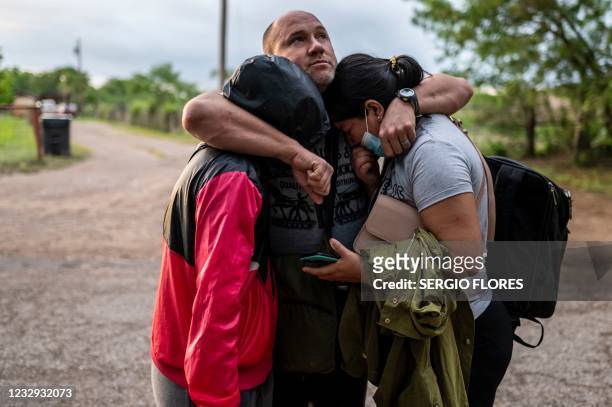 Migrant man embraces his wife and daughter after crossing the Rio Grande near the border between Mexico and the United States in Del Rio, Texas on...