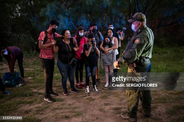 Migrant family waits to be processed after being apprehended near the border between Mexico and the United States in Del Rio, Texas on May 16, 2021....