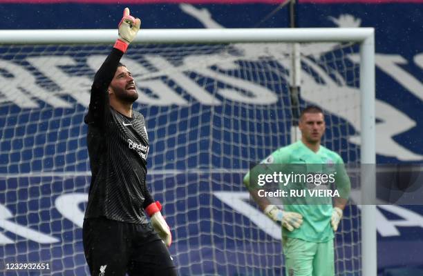 West Bromwich Albion's English goalkeeper Sam Johnston looks on as Liverpool's Brazilian goalkeeper Alisson Becker celebrates scoring his team's...