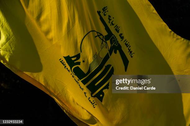 Someone carries a Hezbollah flag during a demonstration to show solidarity with Palestinians near the Lebanon-Israel border on May 16, 2021 in...