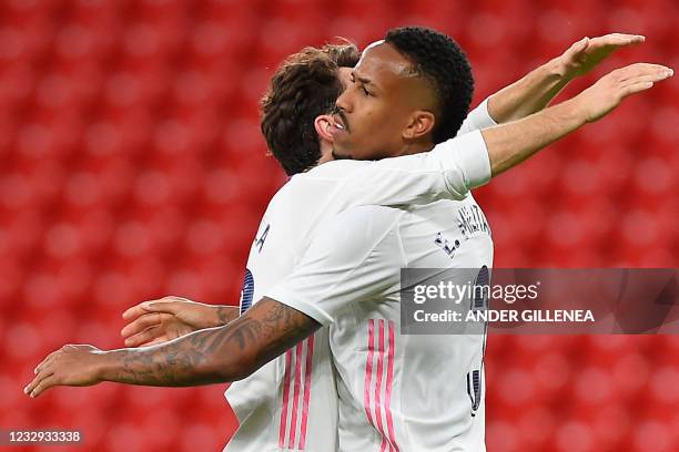 Real Madrid's Spanish defender Alvaro Odriozola celebrates with Real Madrid's Brazilian defender Eder Militao at the end of the Spanish League...