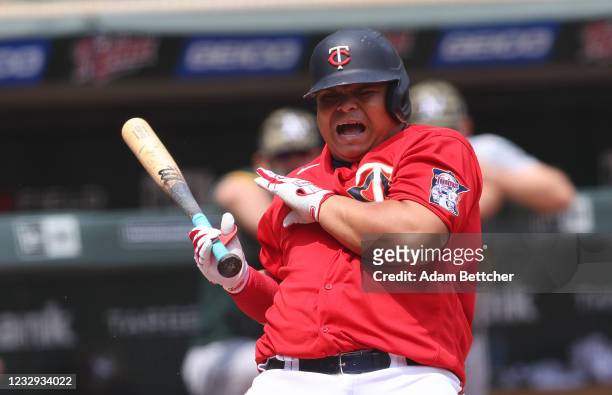 Willians Astudillo of the Minnesota Twins gets hit by a pitch in the second inning against the Oakland Athletics at Target Field on May 16, 2021 in...