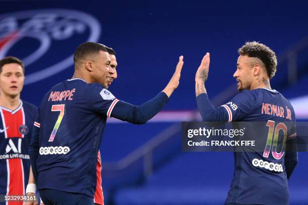 Paris Saint-Germain's Brazilian forward Neymar is congratulated by Paris Saint-Germain's French forward Kylian Mbappe after scoring on a penalty kick...