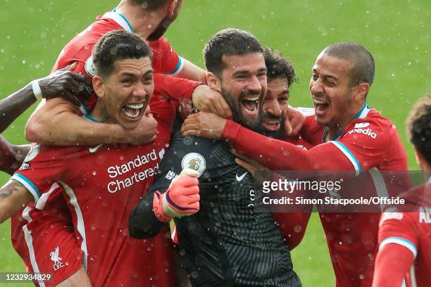 Liverpool goalkeeper Alisson Becker celebrates with teammates after scoring their 2nd goal during the Premier League match between West Bromwich...