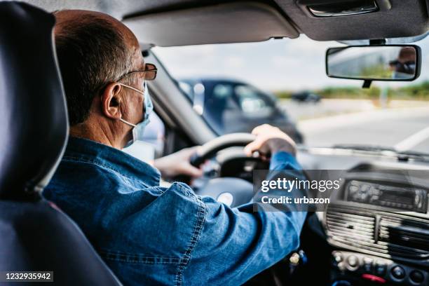 taxi driver wearing protective mask at work - taxi driver stock pictures, royalty-free photos & images