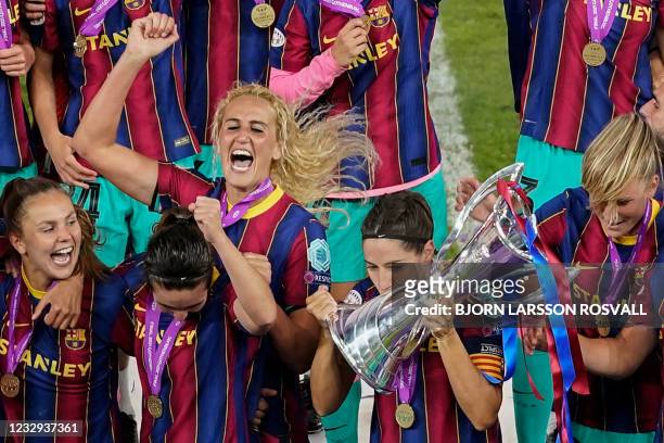 Barcelona's Spanish midfielder Vicky Losada and her teammates celebrate with the trophy after winning the UEFA Women's Champions League final between...