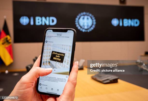 May 2021, Berlin: An employee shows at the headquarters of the Federal Intelligence Service , a photo with a postcard with the inscription "Love...