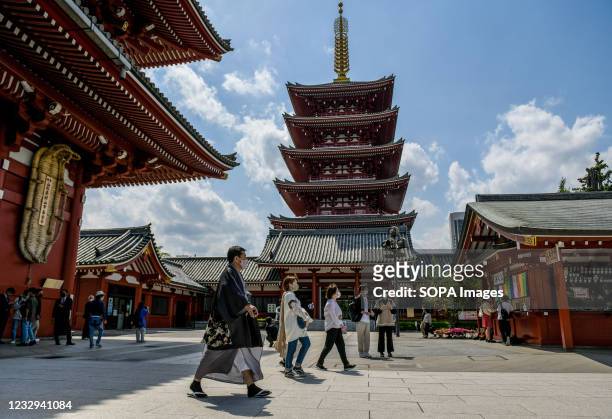 People wearing face masks as a precaution against the spread of covid-19 seen inside Senso-ji Buddhist temple, Tokyo's oldest temple, located in...