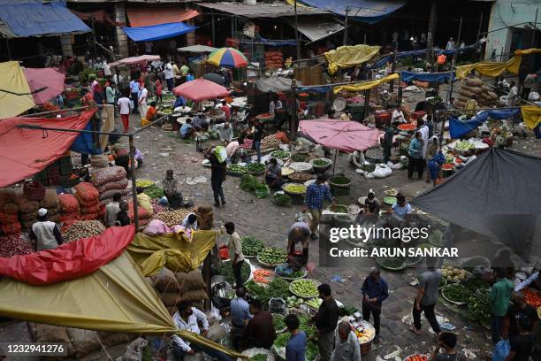 People are seen at a wholesale vegetable market in New Delhi on May 17 as the capital continues a lockdown amid the Covid-19 coronavirus pandemic.