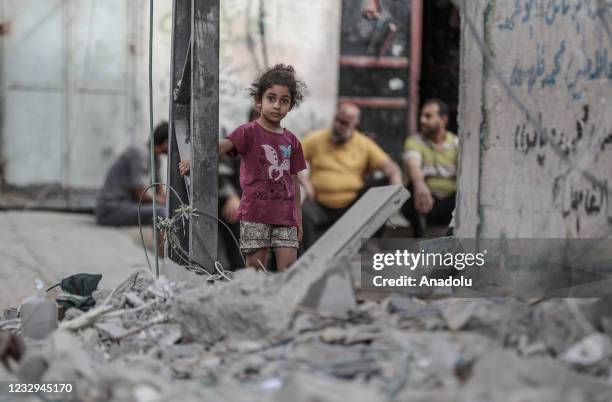 Palestinian Al Deyri family's children are seen at street after their home demolished by Israeli army's airstrikes in Gaza City, Gaza on May 17, 2021.