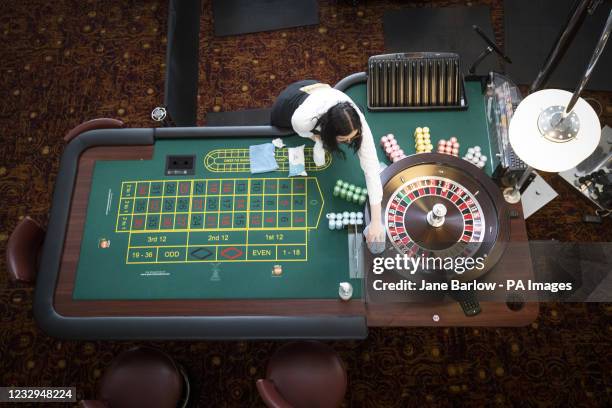 Croupier Julia Linton cleans the roulette tables at the Grosvenor Edinburgh Maybury Casino ahead of opening as most of Scotland moves to Level 2...