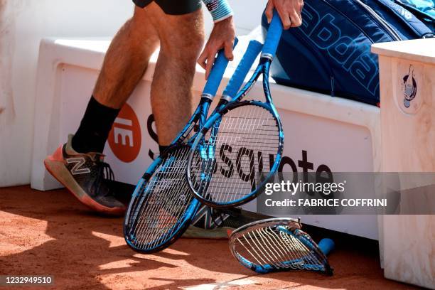 Australia's Jordan Thompson chooses an another racket after he destroyed one during his match against Spain's Pablo Andujar on the second day of the...