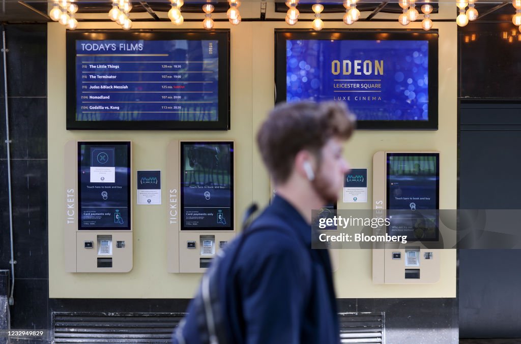 Outside Ticket Machine A pedestrian passes automatic ticket machines outside the Odeon... News ...