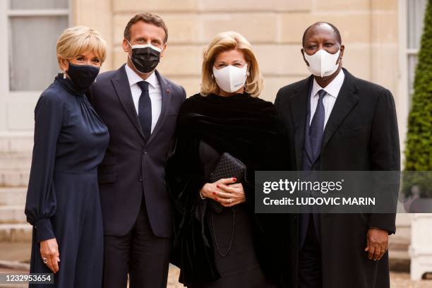 France's President Emmanuel Macron and his wife Brigitte Macron , welcome Ivory Coast's President Alassane Ouattara and his wife Dominique...