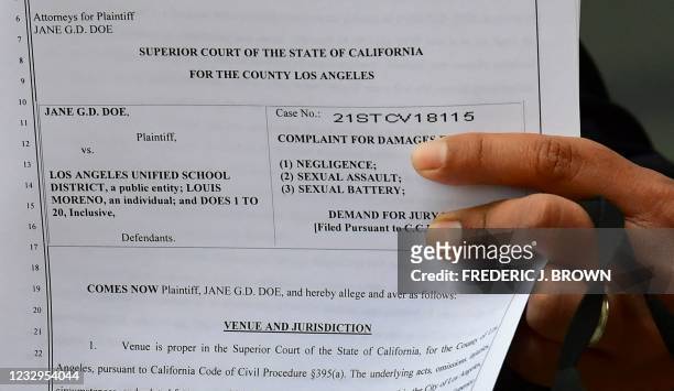 Attorney Michael Carrillo displays a copy of the lawsuit filed against the Los Angeles Unified School District by Jane Doe on May 16, 2021 in Los...