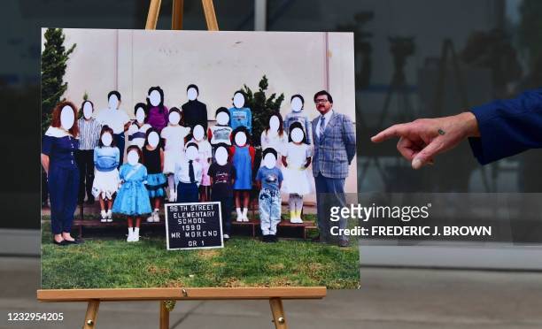 Attorney Luis Carrillo points out teacher Louis Moreno in Jane Doe's elementary school photo while addressing the media on the lawsuit filed against...