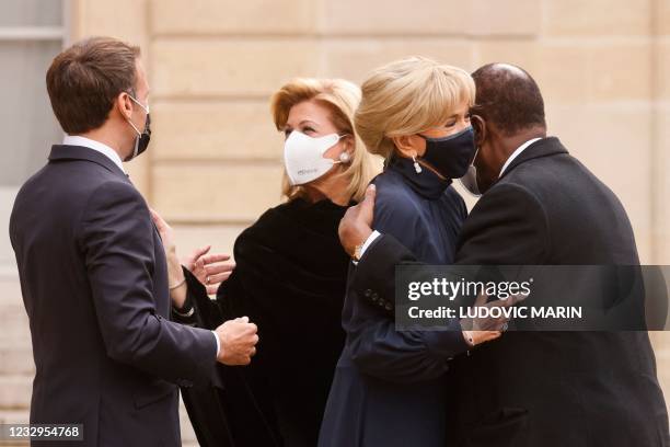 France's President Emmanuel Macron and his wife Brigitte Macron welcome Ivory Coast President Alassane Ouattara and his wife Dominique...