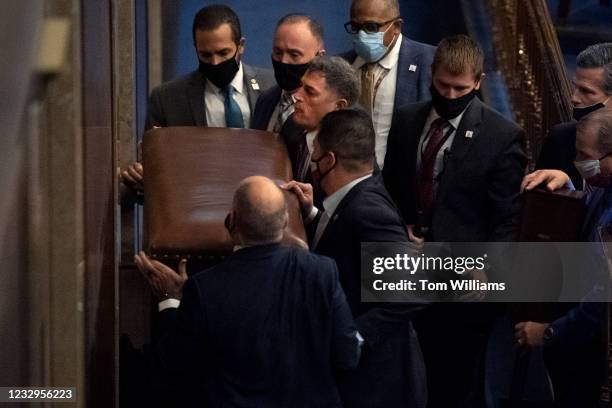 Rep. Andrew Clyde, R-Ga., third from top left, and security barricade the House chamber door as rioters disrupt the joint session of Congress to...