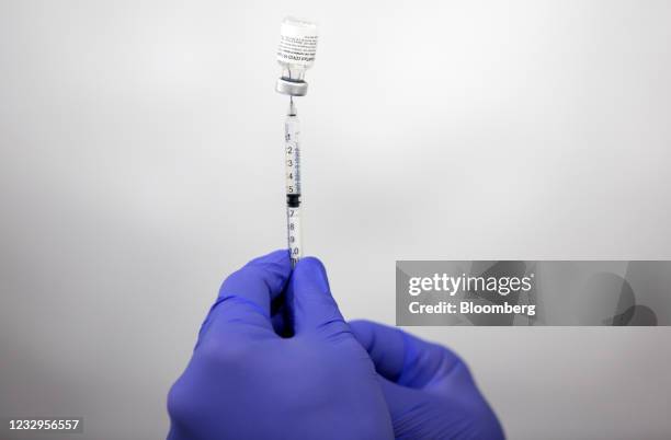 Healthcare worker prepares Pfizer-BioNTech Covid-19 vaccines at the Oregon Health & Science University mass vaccination site at Portland...