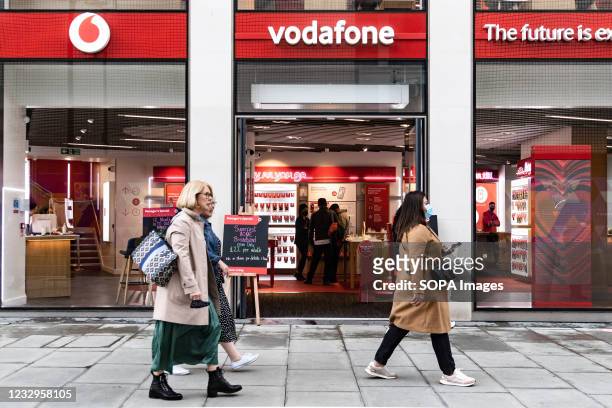 People passing Vodafone telecom shop. The Prime Minister announced that England can proceed to Stage Three on May 17, 2021. Most shops can reopen...