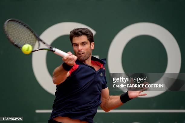Spain's Pablo Andujar returns the ball to Switzerland's Roger Federer during their match at the ATP 250 Geneva Open tennis tournament on May 18, 2021...