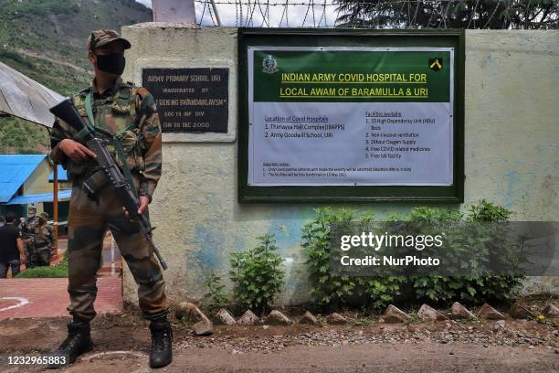 An Indian Army Jawan Stands Guard outside a School turned COVID-19 Hospital in Uri, Baramulla, Jammu and Kashmir, India on 18 May 2021. Indian Army...