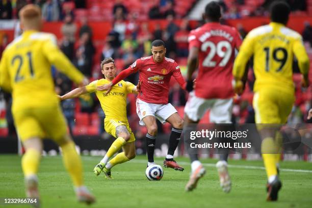 Fulham's English defender Joe Bryan vies with Manchester United's English striker Mason Greenwood during the English Premier League football match...