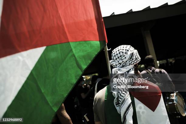 Pro-Palestinian supporter holds a flag during a protest against the Israel-Hamas crisis in Dearborn, Michigan, U.S., on Tuesday, May 18, 2021....