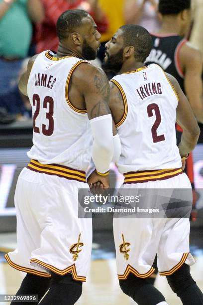 LeBron James and Kyrie Irving of the Cleveland Cavaliers celebrate a dunk by James in the first half of Game One of the Eastern Conference Semifinals...