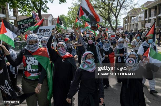 Protesters march through neighborhoods near a Ford Motor Company plant in Dearborn, Michigan on May 18 where US President Joe Biden is touring, to...