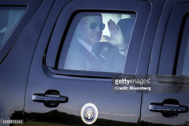 President Joe Biden waves from his motorcade after arriving on Marine One on the Ellipse near the White House in Washington, D.C., U.S., on Tuesday,...