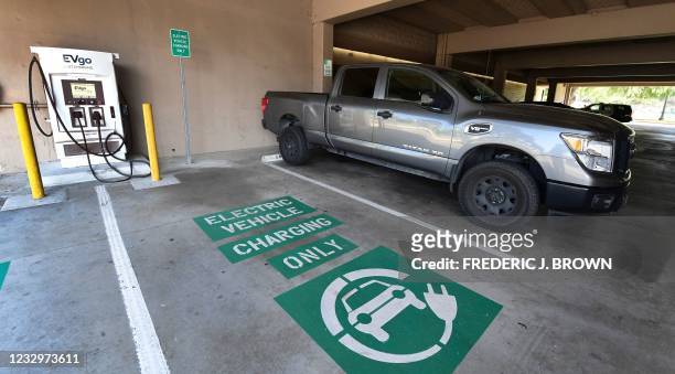 Space remains open for an electric vehicle at a EV charging station in Monterey Park, California on May 18, 2021. - President Joe Biden's...