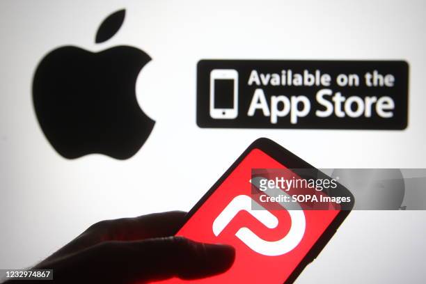 In this photo illustration the Parler logo of a social network is seen on a smartphone screen with an Apple logo in the background.