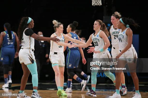 Sabrina Ionescu of the New York Liberty high-fives teammates during the game against the Minnesota Lynx on May 18, 2021 at Barclays Center in...