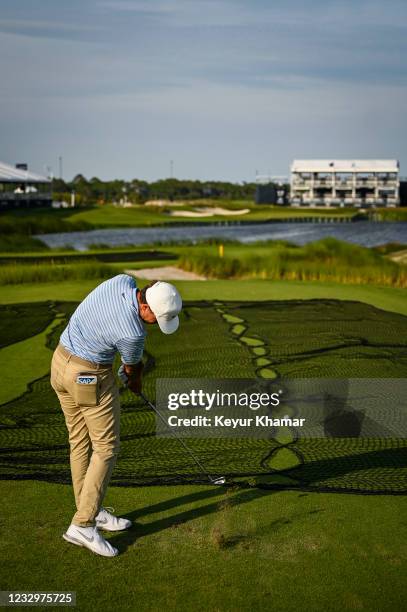 Cameron Champ hits a 4-iron shot into the water from the back tee on the 17th hole during practice for the PGA Championship on The Ocean Course at...